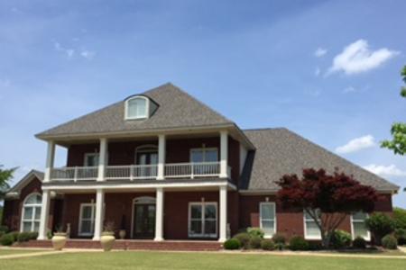 Trotman Brothers Roofing re-roof this home after tornado damage. 