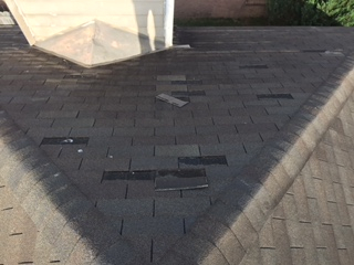 Wind-damaged shingles on a home in Troy, Alabama.