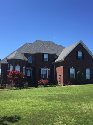 Residential home with moire black shingles roofing.